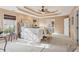 Spacious bedroom showcasing neutral tones, tray ceiling, and large bed with luxurious linens at 230 Bluff Oak Dr, Roswell, GA 30076