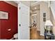Hallway powder room featuring red walls, modern fixtures and a door leading outside at 230 Bluff Oak Dr, Roswell, GA 30076