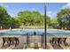 Community tennis courts with players and available seating, perfect for recreational play and exercise at 230 Bluff Oak Dr, Roswell, GA 30076
