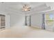 Large bedroom with a tray ceiling, ceiling fan, two windows and a door into the Primary bath at 4238 Linworth Blvd, Austell, GA 30106