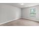 This bedroom features neutral walls and flooring along with a large window at 4238 Linworth Blvd, Austell, GA 30106
