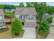 Aerial view of a two-story home with gray siding, a two-car garage, and a landscaped front yard at 4238 Linworth Blvd, Austell, GA 30106