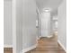Hallway with wood floors, white doors and a view to the kitchen area in the distance at 4238 Linworth Blvd, Austell, GA 30106