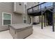 Backyard patio featuring a modern grey home with a staircase, deck, and a secluded hot tub with cover at 4238 Linworth Blvd, Austell, GA 30106