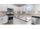 Modern kitchen featuring stainless steel appliances, granite countertops, and white cabinets at 4238 Linworth Blvd, Austell, GA 30106