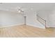 Bright living room featuring hard wood floors, a ceiling fan and staircase to the upper level at 4238 Linworth Blvd, Austell, GA 30106
