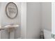 Well-lit powder room with pedestal sink and neutral decor, perfect for guests at 4238 Linworth Blvd, Austell, GA 30106