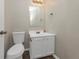 Compact bathroom with a vanity and updated fixtures in a well-lit and functional space at 565 Lake Joyce Ln, Fairburn, GA 30213