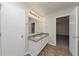 Bathroom with granite countertops, dual sinks, and tile flooring at 565 Lake Joyce Ln, Fairburn, GA 30213