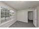 This bedroom features gray carpeting, neutral paint, and a window offering plenty of light at 565 Lake Joyce Ln, Fairburn, GA 30213