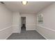 A bedroom provides neutral paint, gray carpet, and a window that lets in lots of natural light at 565 Lake Joyce Ln, Fairburn, GA 30213