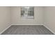 A well-lit bedroom features neutral walls, gray carpet, and a window for natural light at 565 Lake Joyce Ln, Fairburn, GA 30213