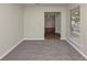 A bright and neutral room with carpet flooring, a window, and natural light at 565 Lake Joyce Ln, Fairburn, GA 30213