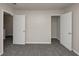 A bedroom offers gray carpet and two open doorways, one to a closet for ample storage at 565 Lake Joyce Ln, Fairburn, GA 30213