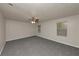 A spacious bedroom with gray carpet, neutral paint, ceiling fan, and two windows for natural light at 565 Lake Joyce Ln, Fairburn, GA 30213