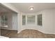 Bright breakfast nook with large windows and modern flooring, adjacent to the kitchen at 565 Lake Joyce Ln, Fairburn, GA 30213