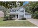 Charming home with a welcoming front porch, two-car garage, and well-manicured landscaping at 565 Lake Joyce Ln, Fairburn, GA 30213