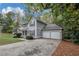 Two-story home featuring a two-car garage, gray siding, and a well-maintained front lawn at 565 Lake Joyce Ln, Fairburn, GA 30213