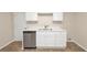 Functional kitchen features white cabinetry, modern countertops, and stainless steel dishwasher appliance at 565 Lake Joyce Ln, Fairburn, GA 30213