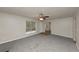 Open concept living room with fireplace and large window, creating a bright and inviting space at 565 Lake Joyce Ln, Fairburn, GA 30213
