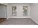 Living room featuring neutral walls, plush carpet, and bright windows at 565 Lake Joyce Ln, Fairburn, GA 30213