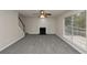 Spacious living room features gray carpet, a cozy fireplace, and a modern ceiling fan at 565 Lake Joyce Ln, Fairburn, GA 30213