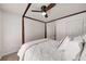 Bright bedroom featuring a four-post bed, ceiling fan, and white walls with a light-colored carpet at 10204 Deep Creek Pl, Union City, GA 30291