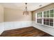 Elegant dining room featuring hardwood floors, decorative wainscoting and a modern light fixture at 10204 Deep Creek Pl, Union City, GA 30291