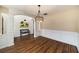 Bright dining area with wood flooring, wainscoting detail, and modern lighting perfect for Gathering gatherings at 10204 Deep Creek Pl, Union City, GA 30291