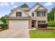 Charming two-story home featuring a brick facade, attached two-car garage and well-maintained lawn at 10204 Deep Creek Pl, Union City, GA 30291