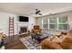 Cozy living room features a fireplace, dark wood floors, and plenty of natural light from multiple windows at 10204 Deep Creek Pl, Union City, GA 30291