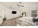 Main bedroom boasting a ceiling fan, tv, and ample natural light at 10204 Deep Creek Pl, Union City, GA 30291