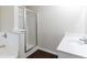Bathroom featuring white cabinets and shower, white tiled walls at 1646 Sandy Beach Point, Lawrenceville, GA 30043