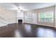 Spacious living room with a fireplace, hardwood floors, bright windows, and plenty of natural light at 1646 Sandy Beach Point, Lawrenceville, GA 30043