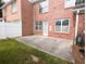 Brick home featuring a concrete patio, white fence, and green lawn, ideal for outdoor living at 2656 Gadsen Walk, Duluth, GA 30097
