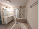 Spacious bathroom with tile flooring, glass-enclosed shower, and separate soaking tub at 2656 Gadsen Walk, Duluth, GA 30097