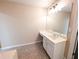 Bright bathroom with a vanity, tiled floor, and white cabinets at 2656 Gadsen Walk, Duluth, GA 30097