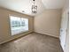 Well-lit bedroom features a large window, neutral walls, modern light fixture, and plush carpeting at 2656 Gadsen Walk, Duluth, GA 30097