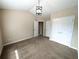 Bright bedroom features a neutral color scheme, carpeted floors, vaulted ceilings, and modern light fixture at 2656 Gadsen Walk, Duluth, GA 30097