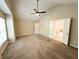 Open and bright bedroom featuring a ceiling fan, neutral carpet, and ensuite bathroom at 2656 Gadsen Walk, Duluth, GA 30097