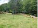 Serene community greenspace with mature trees, park benches and walking path at 2656 Gadsen Walk, Duluth, GA 30097