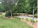 Peaceful view of the community greenspace with wooden benches and lush greenery at 2656 Gadsen Walk, Duluth, GA 30097