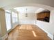 Sunlit dining area with hardwood floors and modern lighting fixture at 2656 Gadsen Walk, Duluth, GA 30097