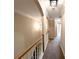 Second floor hallway featuring plush carpet and modern light fixtures at 2656 Gadsen Walk, Duluth, GA 30097