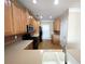 Spacious kitchen featuring wood cabinets, stainless appliances, and hardwood flooring at 2656 Gadsen Walk, Duluth, GA 30097