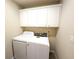 Functional laundry room featuring a modern washer and dryer set and built-in white cabinetry at 2656 Gadsen Walk, Duluth, GA 30097