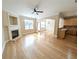 Open-concept living area with fireplace, hardwood floors, and view into kitchen and dining at 2656 Gadsen Walk, Duluth, GA 30097