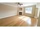Bright living room featuring hardwood floors, a fireplace, and a large window at 2656 Gadsen Walk, Duluth, GA 30097