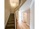 Open staircase with wood railing and hardwood floors adjacent to the hallway at 2656 Gadsen Walk, Duluth, GA 30097