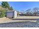 Large backyard with a storage shed and mature trees offering privacy and functionality at 609 Grand Ashbury Ln, Buford, GA 30518